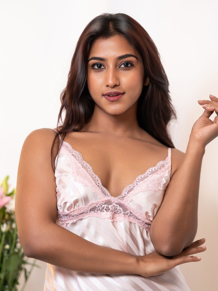 Woman wearing a white lace nightgown against a neutral background