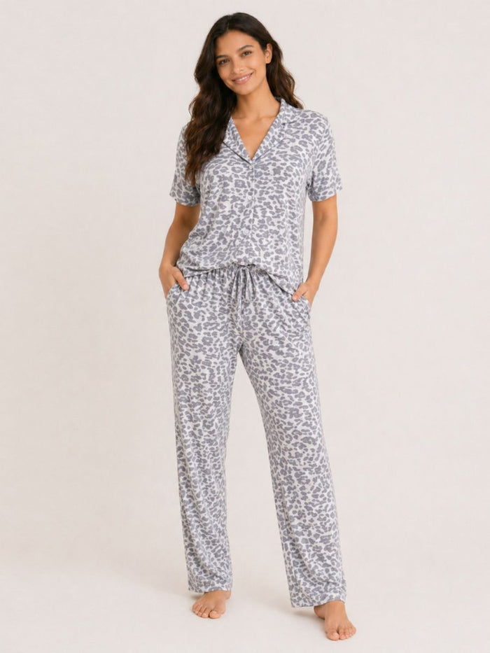Woman wearing a patterned pajama set on a plain background
