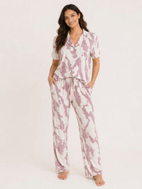 Woman wearing a pink and white tie-dye pajama set on a white background