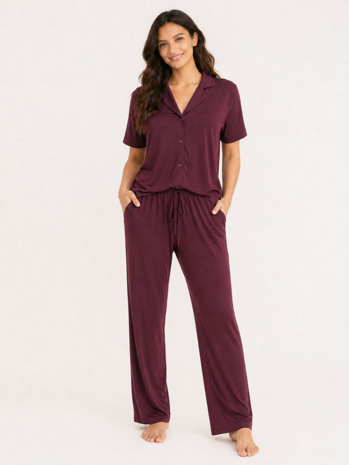 Woman wearing a purple pajama set on a white background