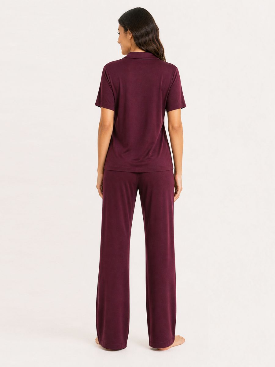 Woman wearing a burgundy outfit on a white background