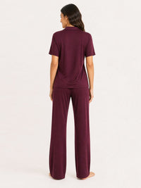 Woman wearing a burgundy outfit on a white background