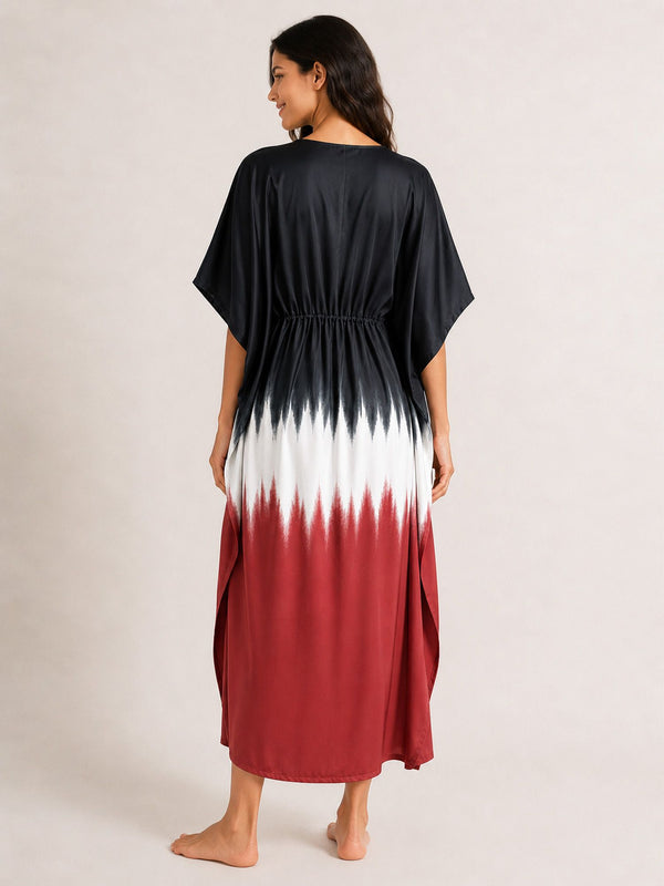 Woman wearing a black, white, and red gradient dress on a plain background
