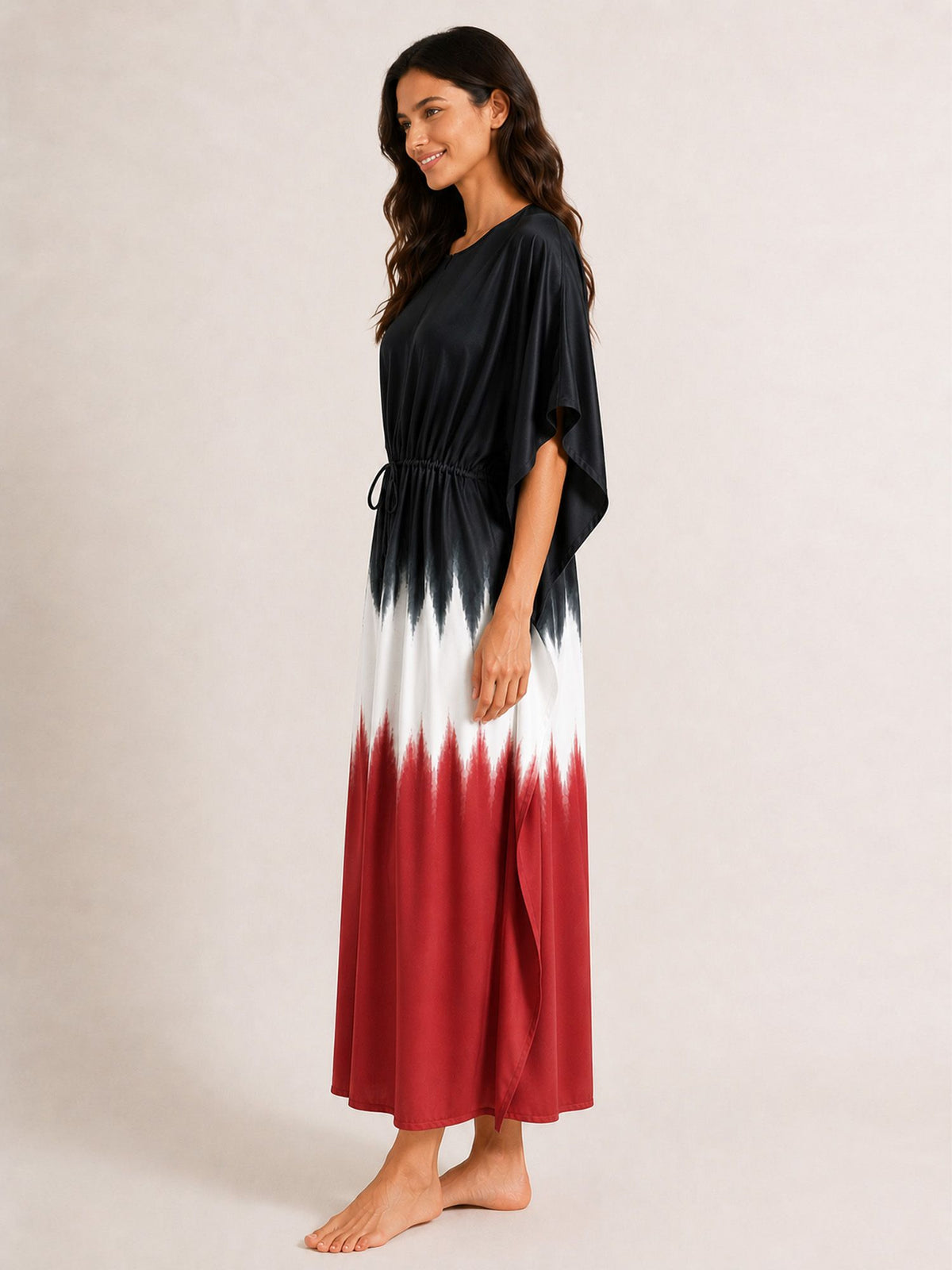 Woman wearing a black, white, and red dress on a beige background