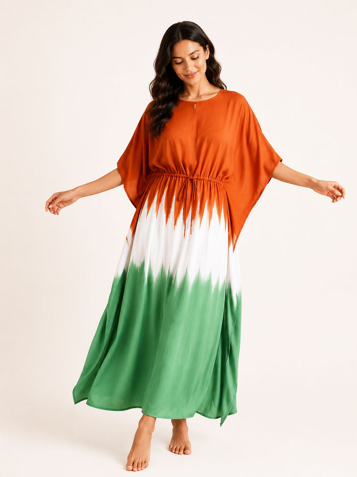 Woman wearing a colorful dress with an orange top, white middle, and green bottom on a white background