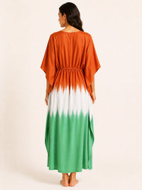 Woman wearing a dress with an orange to green gradient on a beige background