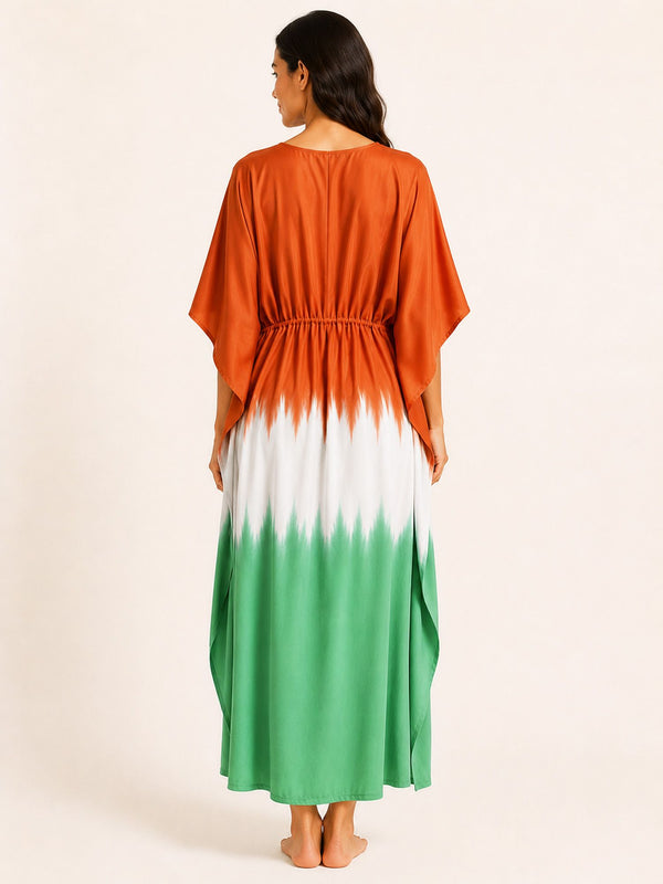 Woman wearing a dress with an orange to green gradient on a beige background