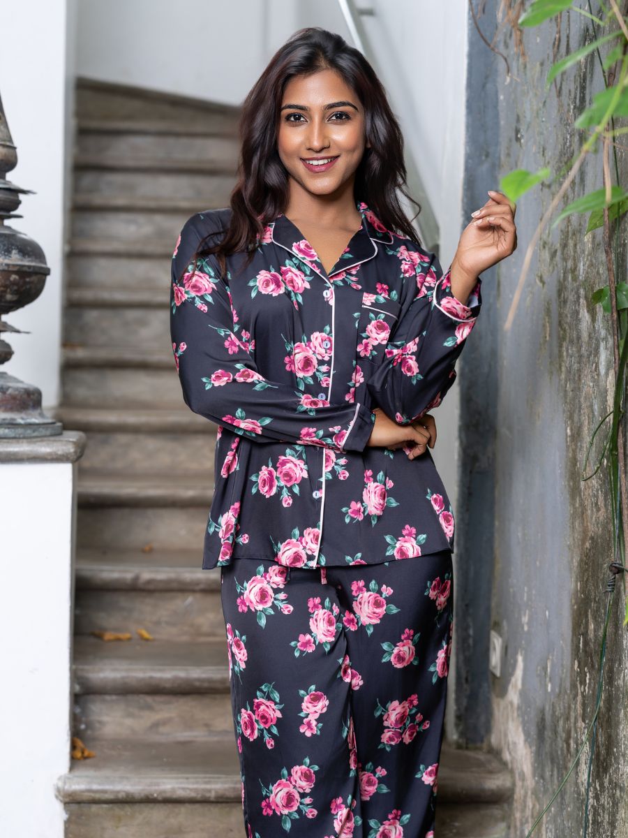 Woman wearing a floral pajama set standing outdoors.