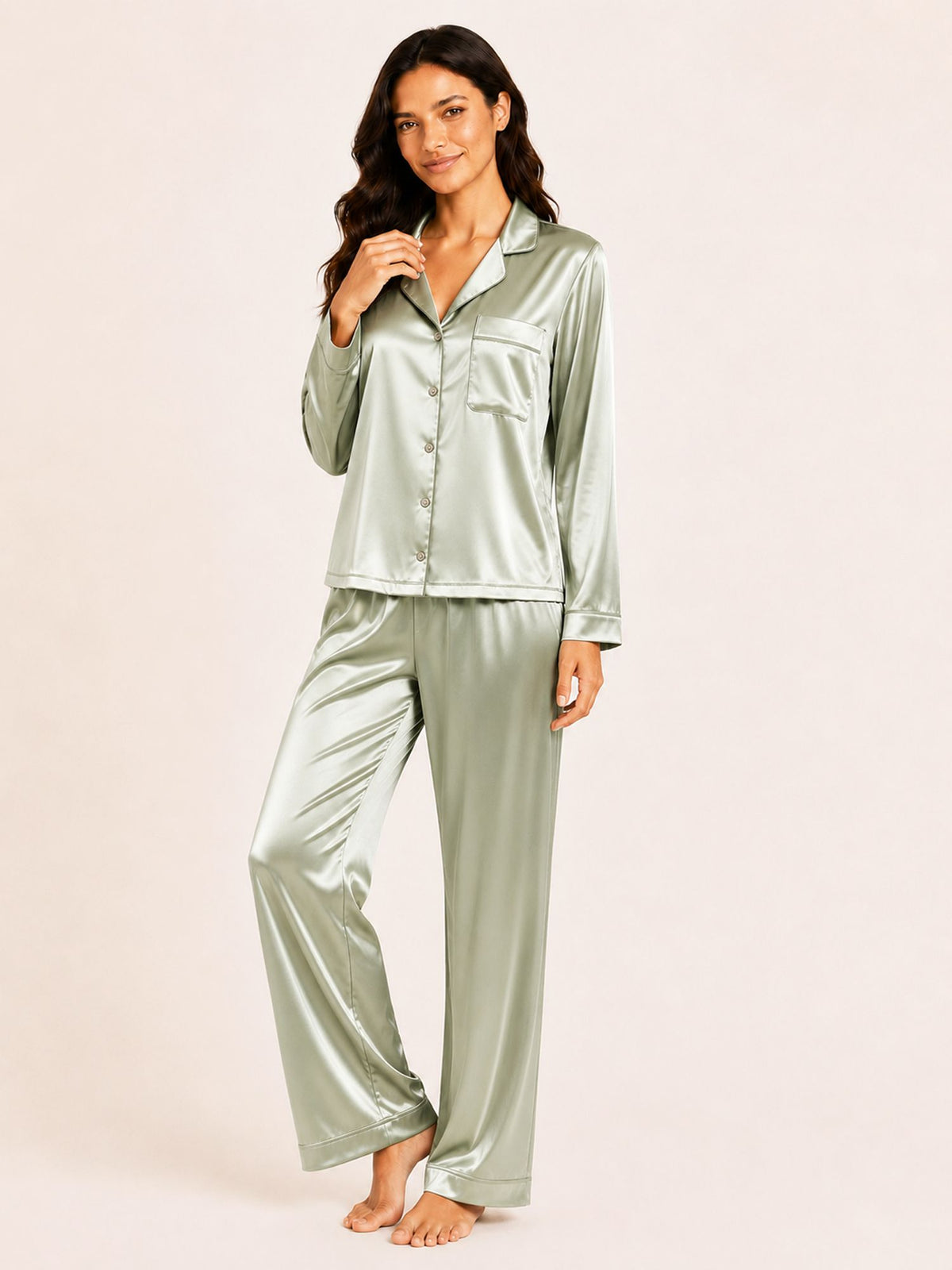 Woman wearing a green satin pajama set on a beige background