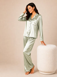 Woman wearing a light green satin pajama set against a beige background