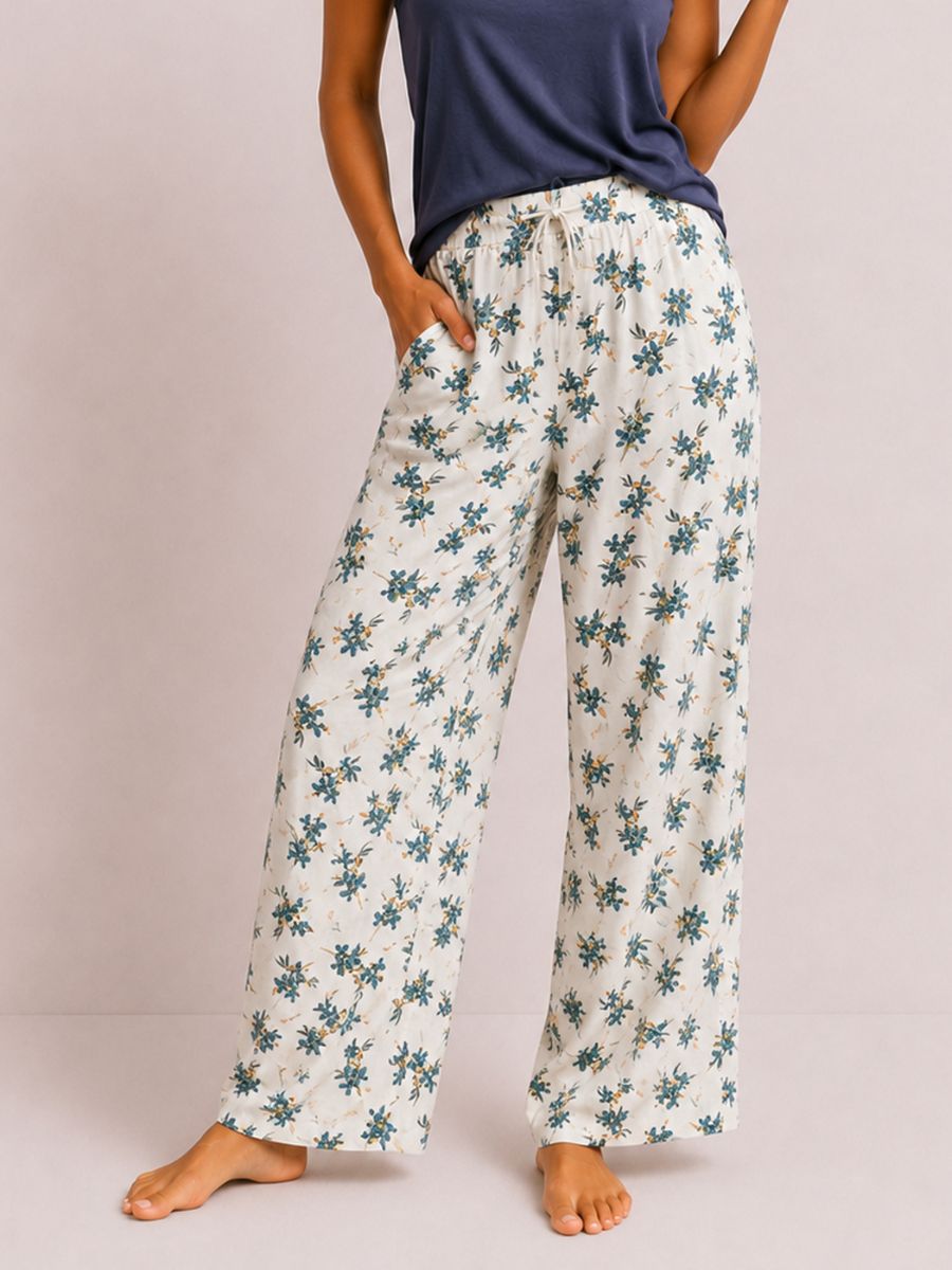 Floral-patterned pants worn by a person on a plain background