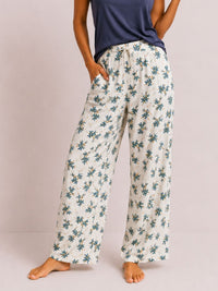 Floral-patterned pants worn by a person on a plain background