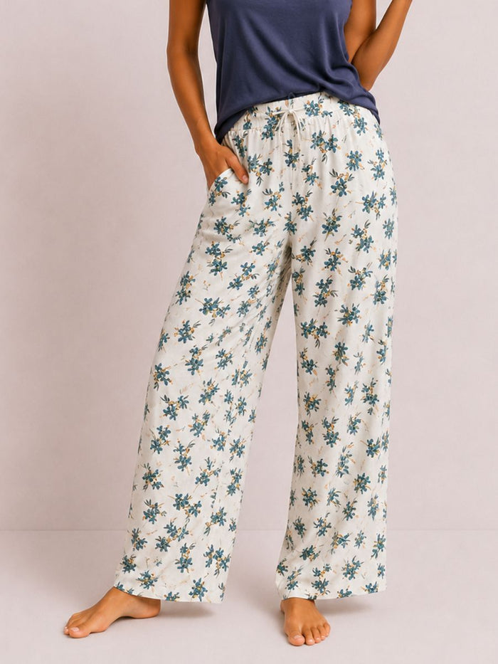 Floral-patterned pants worn by a person on a plain background