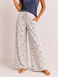 Floral-patterned pants worn by a person on a plain background