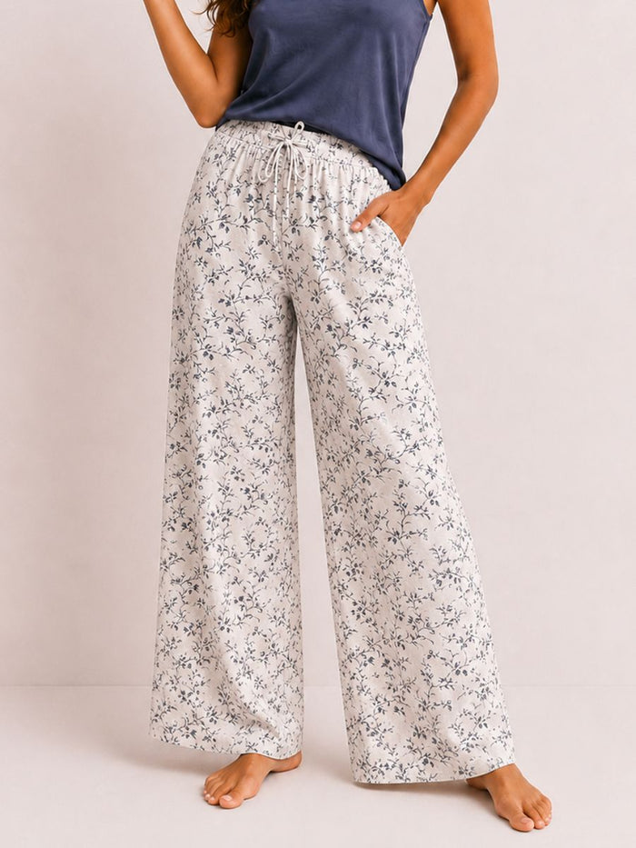 Floral-patterned pants worn by a person on a plain background
