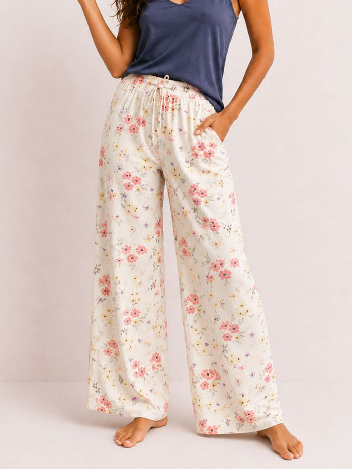 Floral pajama pants worn by a person on a plain background