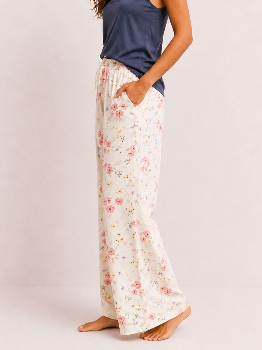 Floral-patterned pants worn by a person on a plain background