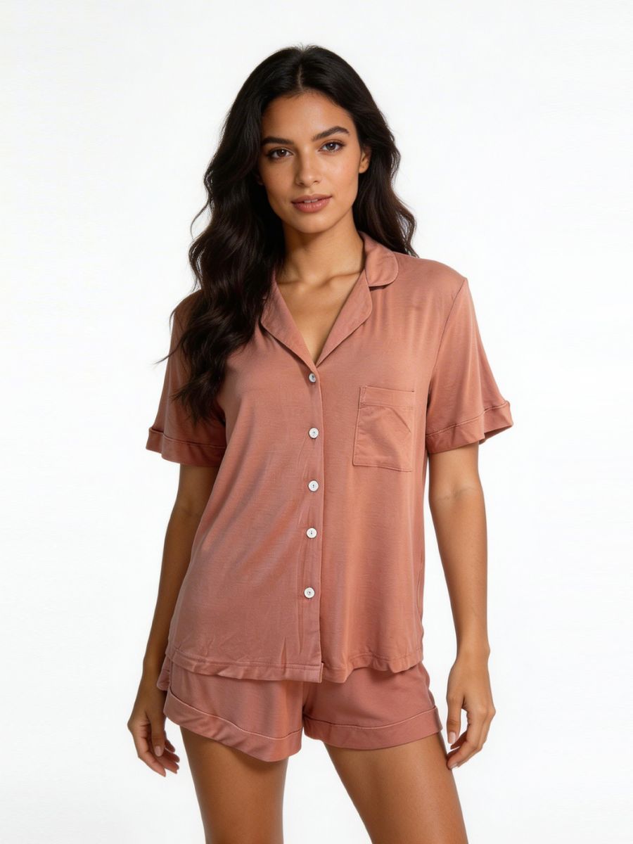 Woman wearing a pink pajama set on a white background