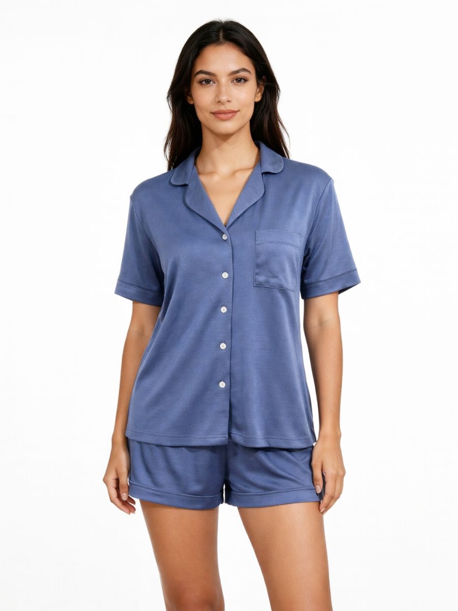 Woman wearing a blue pajama set on a white background