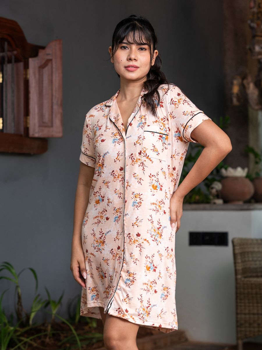 Woman wearing a floral nightshirt in an indoor setting