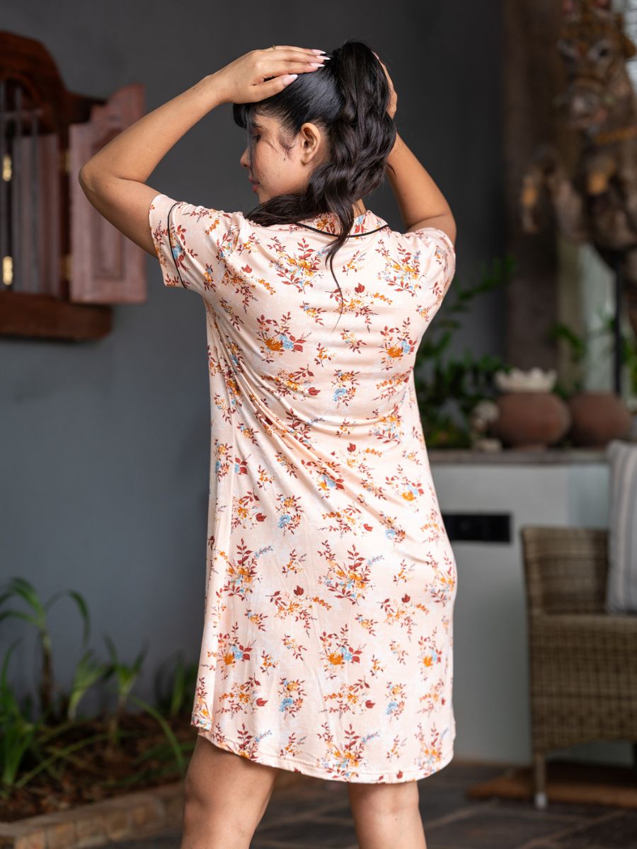 Woman wearing a floral dress in an indoor setting
