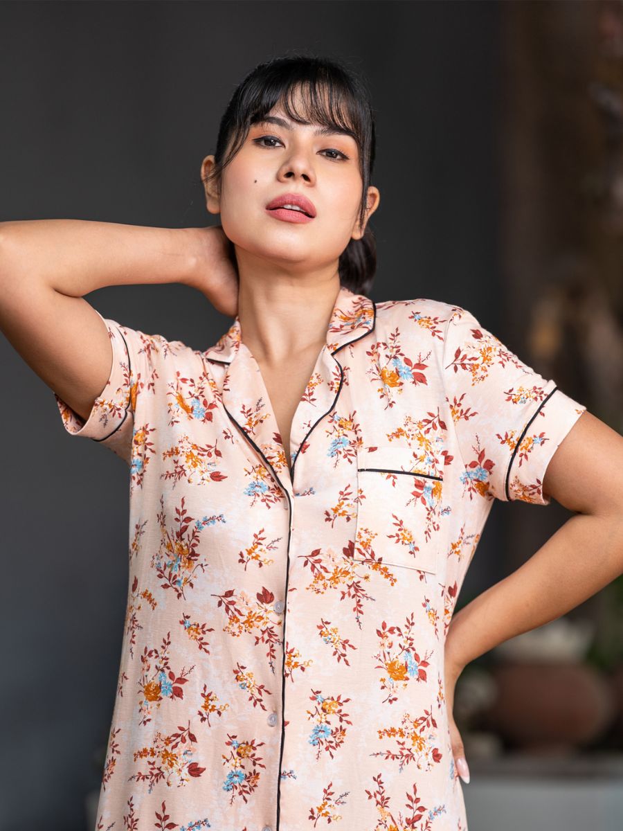 Woman wearing a floral pajama top with a blurred background