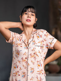 Woman wearing a floral pajama top with a blurred background