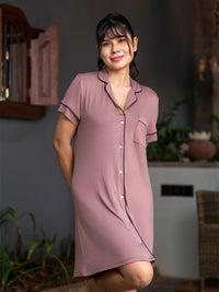 Woman wearing a pink nightshirt in a home setting