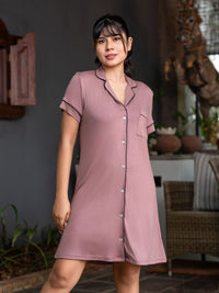 Woman wearing a pink nightshirt in an indoor setting