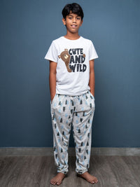 Child wearing a 'Cute and Wild' t-shirt and pajama set against a blue wall.