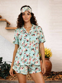 Woman wearing a floral pajama set with a headband in a home setting.