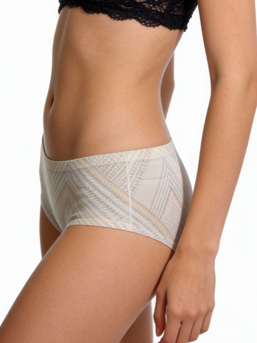 Beige patterned underwear worn by a person on a white background
