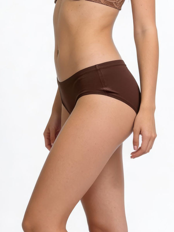 Brown bikini bottom worn by a person on a white background