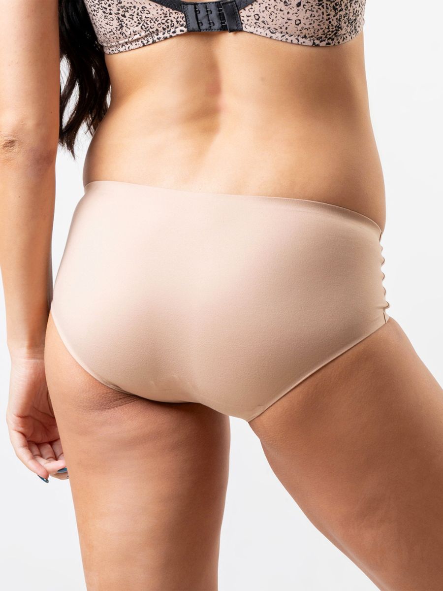 Beige underwear worn by a person on a neutral background