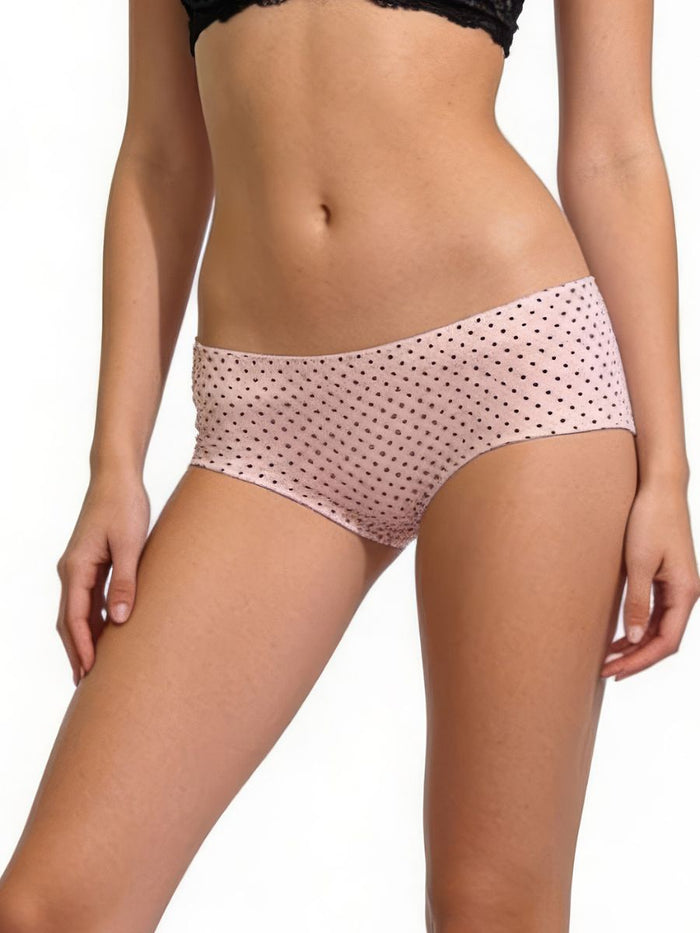 Pink polka dot underwear worn by a model on a white background