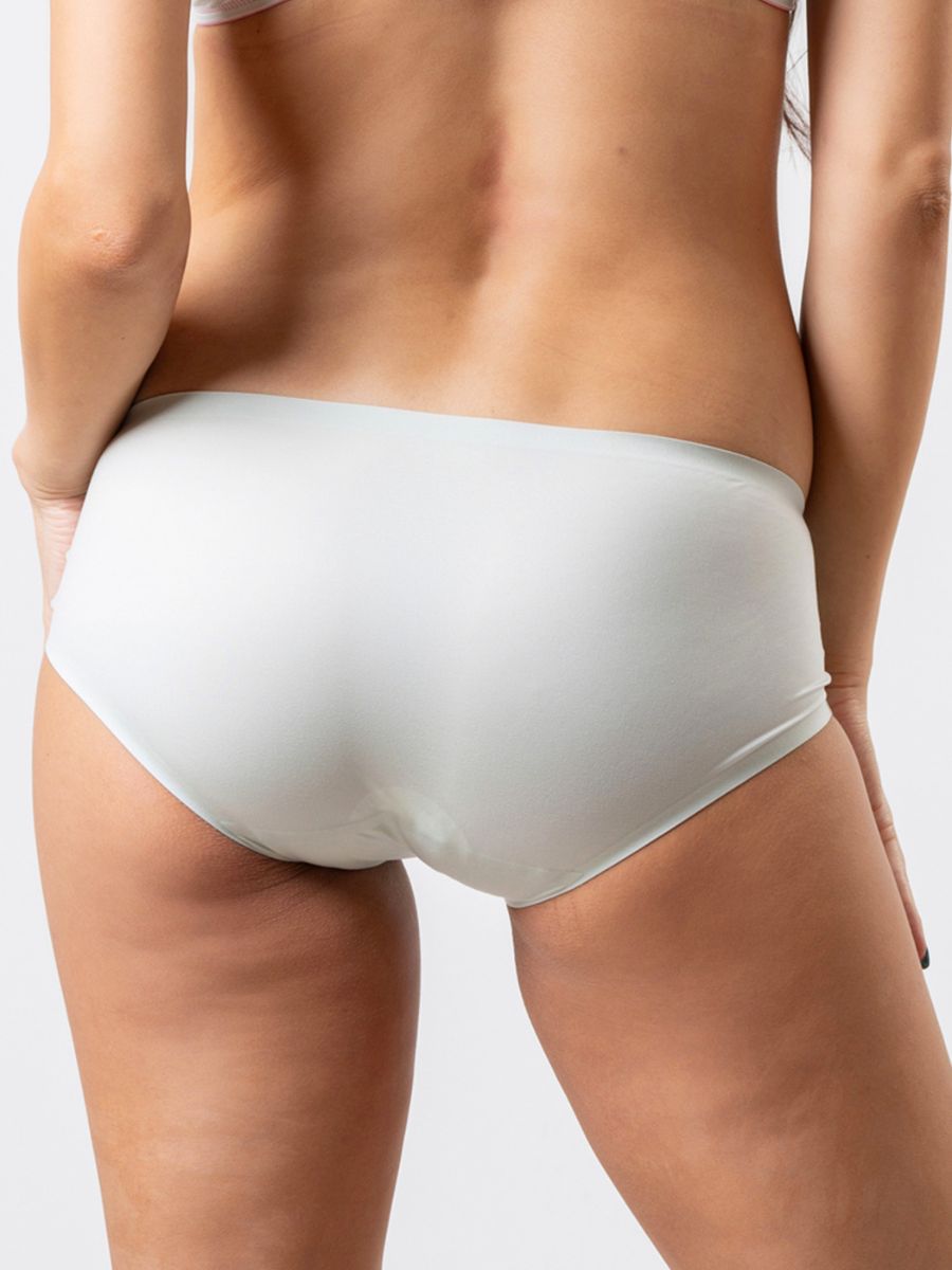 White underwear worn by a person on a plain background