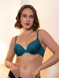 Woman wearing a teal bra against a neutral background