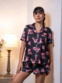 Woman wearing a floral pajama set in a warm indoor setting