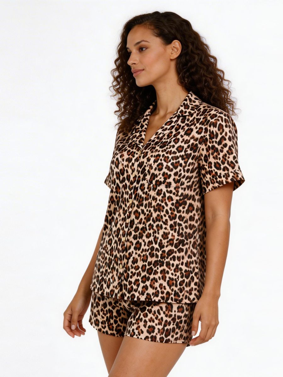 Woman wearing a leopard print pajama set on a white background