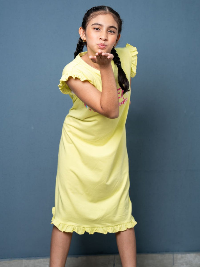Young girl in a yellow dress blowing a kiss against a blue background