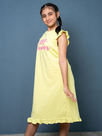 Young girl wearing a yellow dress with pink text against a blue background