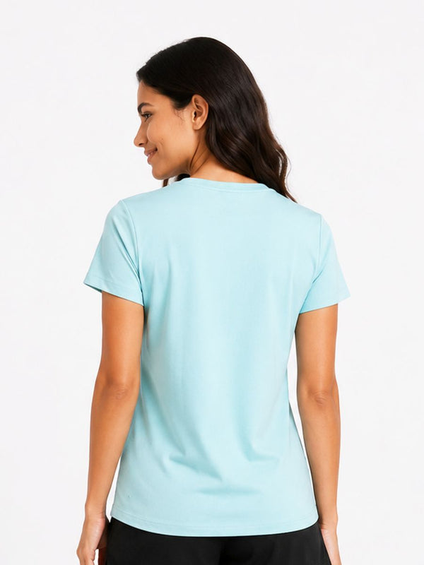 Woman wearing a light blue t-shirt on a plain background
