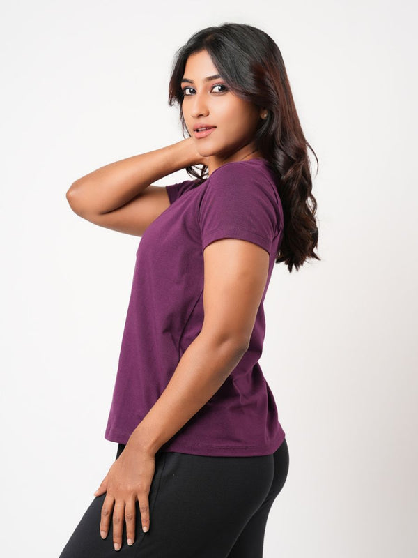 Woman wearing a purple shirt against a white background