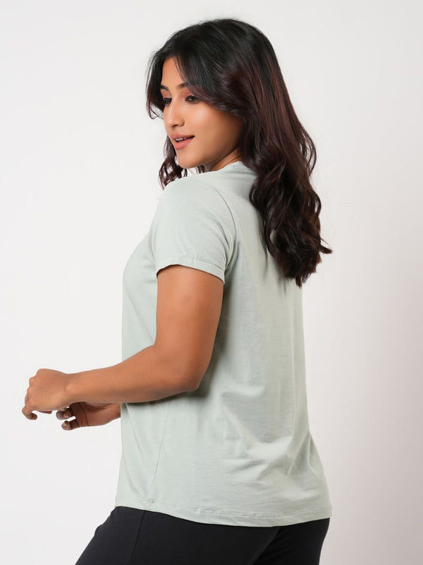 Woman wearing a light gray t-shirt on a white background