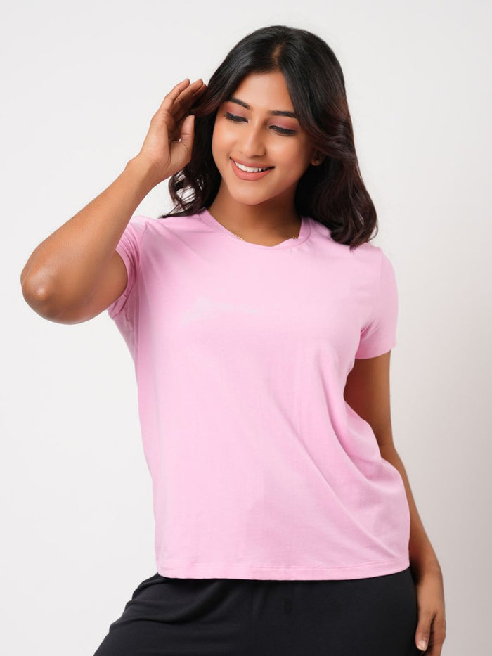 Woman wearing a pink t-shirt against a white background
