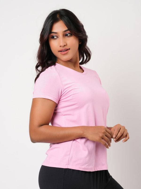 Woman wearing a pink top against a plain background