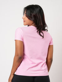 Person wearing a pink t-shirt on a white background