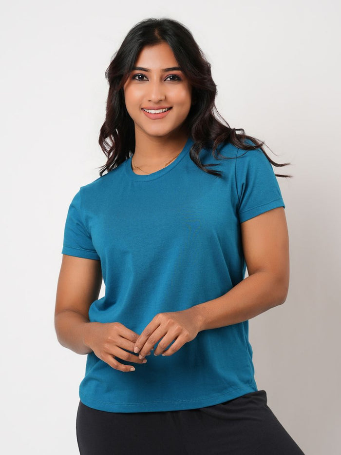 Woman wearing a blue t-shirt against a plain background