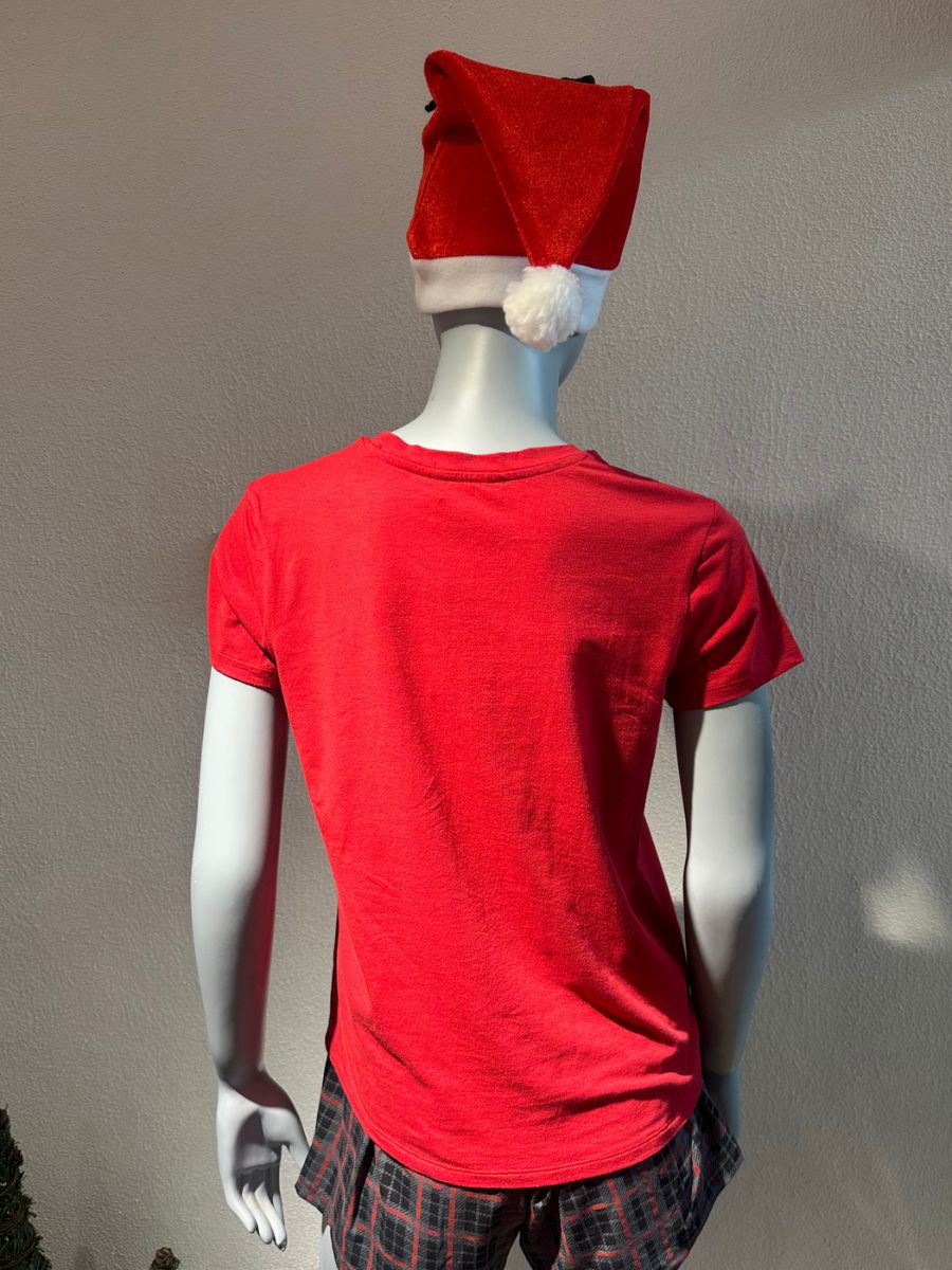 Mannequin wearing a red t-shirt and plaid pants with a red hat on a plain background