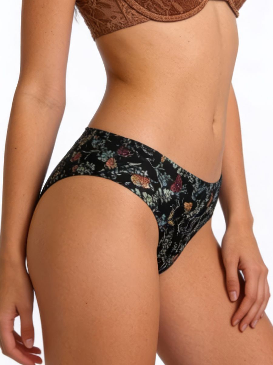 Person wearing a floral-patterned bikini bottom on a white background
